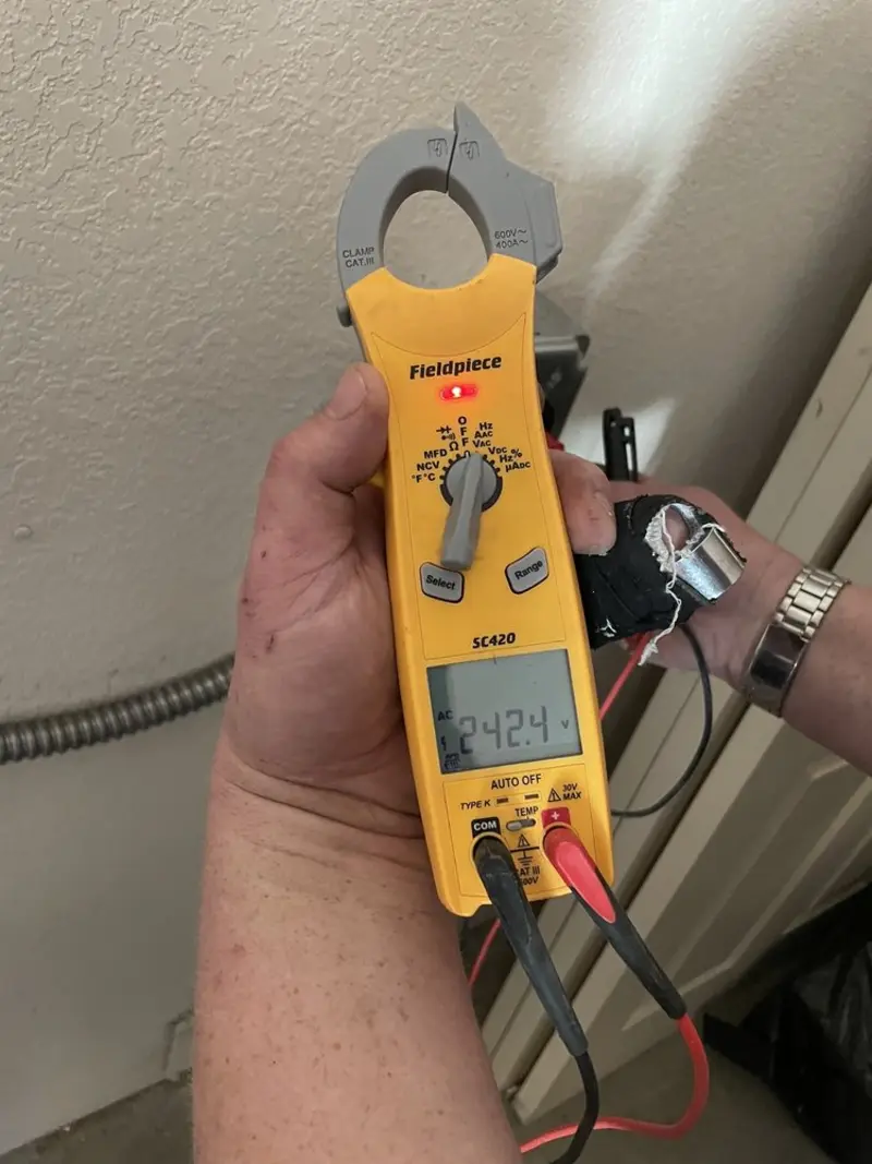 Voltage testing with clamp meter during Recessed Lighting Installation in Vernal
